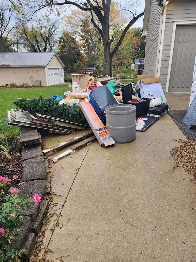 Dumpster being loaded with debris for Estate Cleanout Dumpster Rental in Watergate